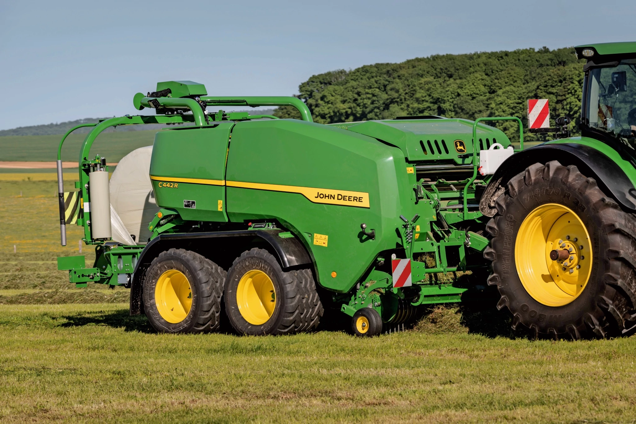 Τυλικτικό χορτοδετικό C442R της John Deere που κάνει δέματα ενσιρώματος υψηλής πυκνότητας